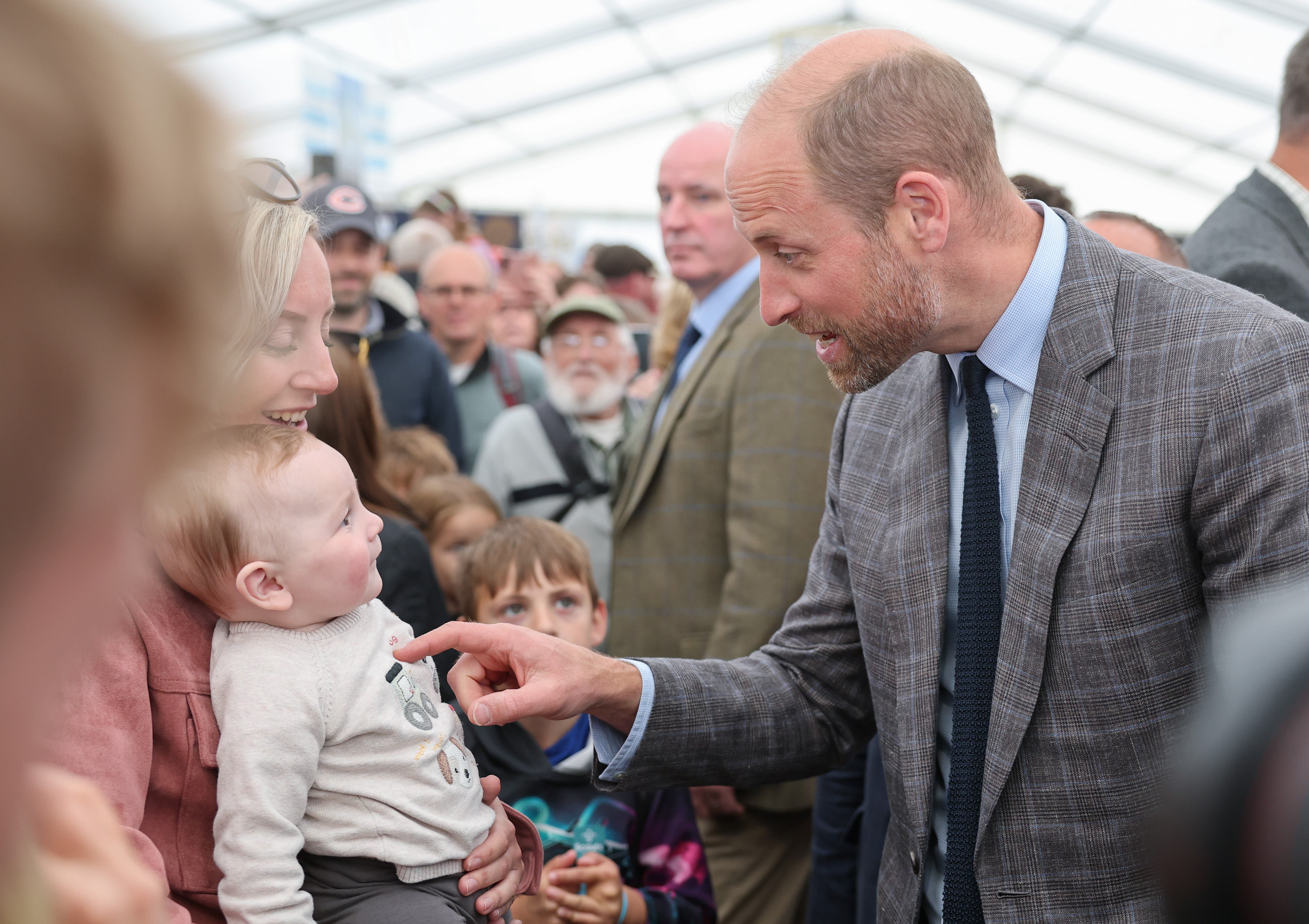 Prince William meeting a baby called George in June 2025 at the Royal Cornwall Show
