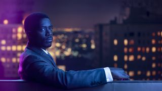 Damson Idris as Franklin Saint sitting on a couch in the promo art for Snowfall season 6