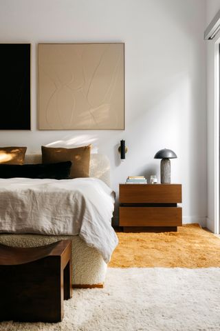 a bedroom with two color wall art