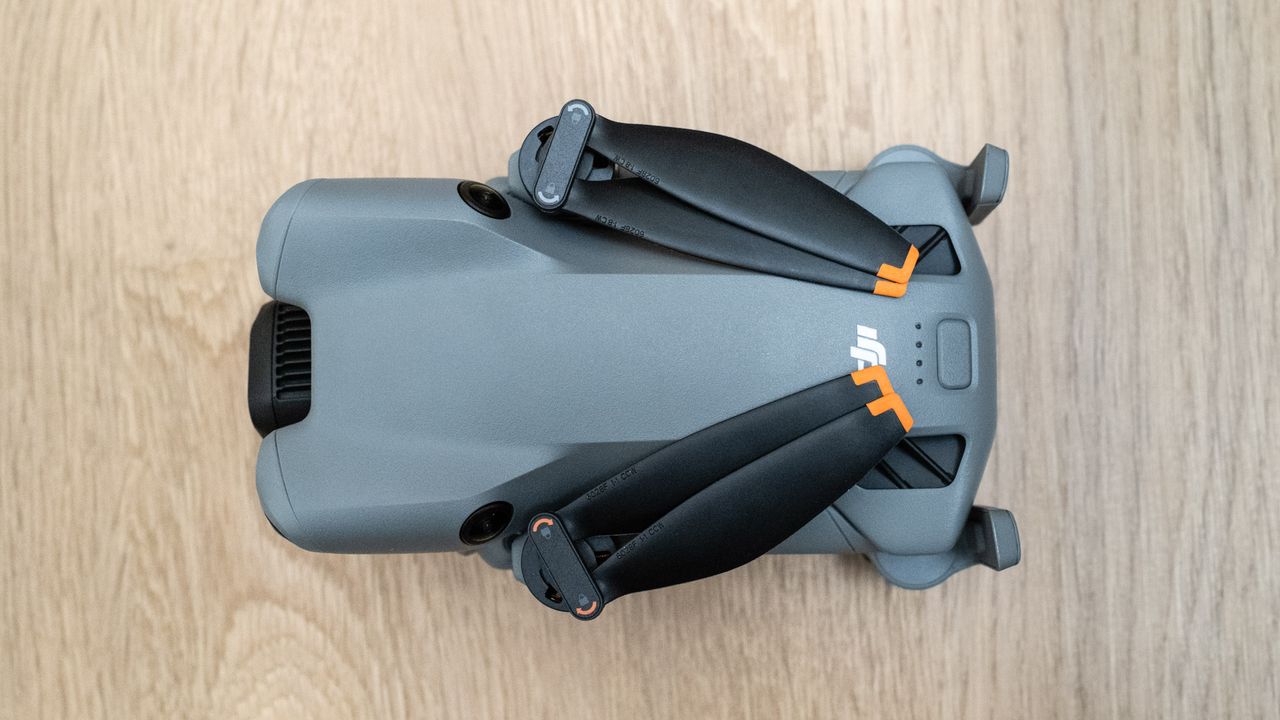 DJI Mini 5 Pro top view on a wooden floor