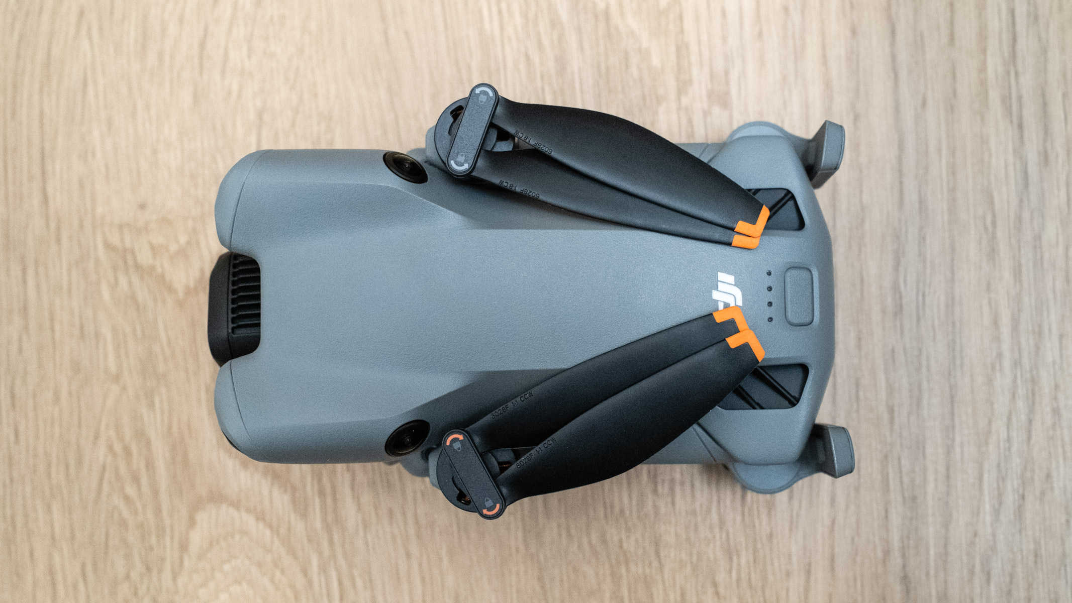 DJI Mini 5 Pro top view on a wooden floor