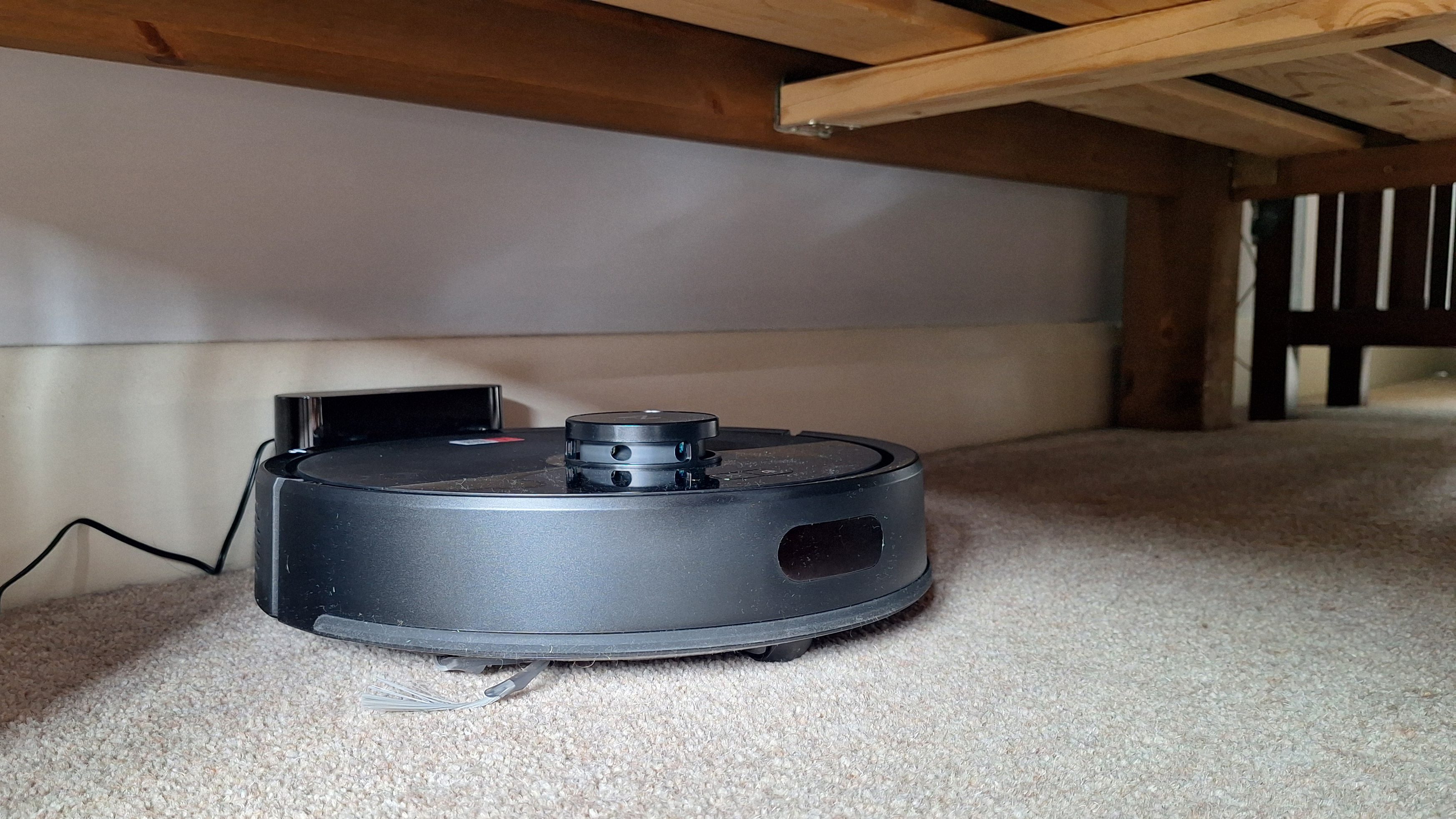 Roborock Q7 M5 robot vacuum under the bed in tester's home