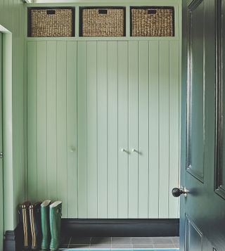 Tall cupboards in a green panelled hallway
