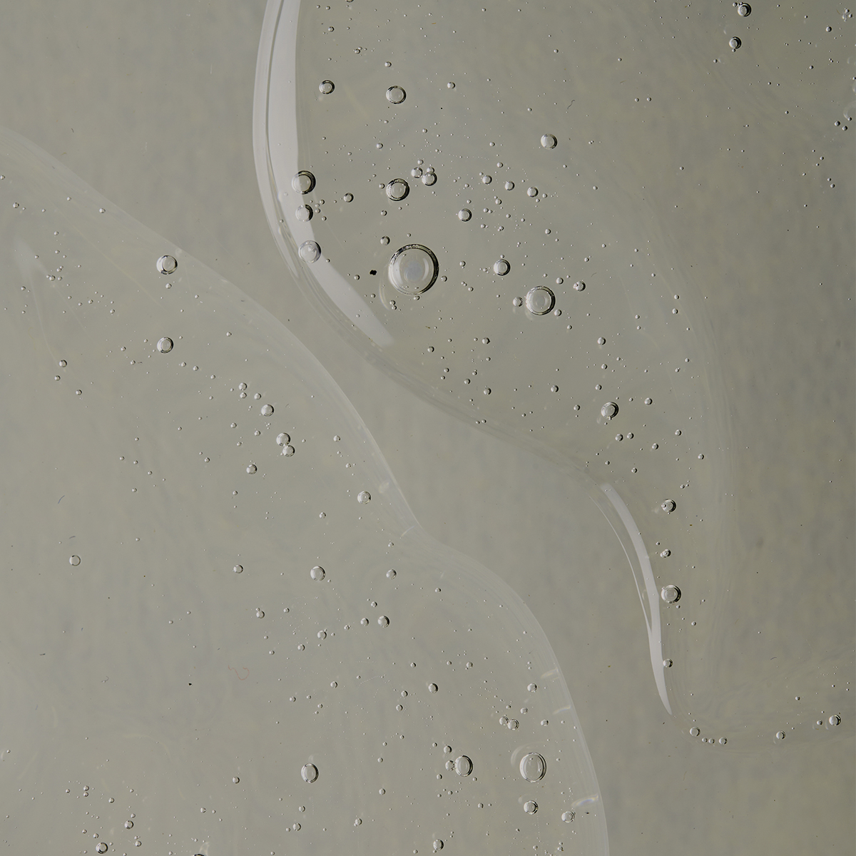 A close-up of a serum skincare texture with tiny bubbles