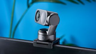 a photograph of a small grey 4K webcam with a gimbal and PTZ functionality