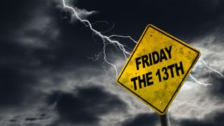 Friday the 13th sign against a stormy background with lightning and copy space. Dirty and angled sign adds to the drama.