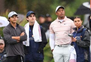 Tiger Woods waits to play his tee shot on the third hole with his son Charlie Woods, his daughter Sam Woods and Charlie's caddie Luke Wise
