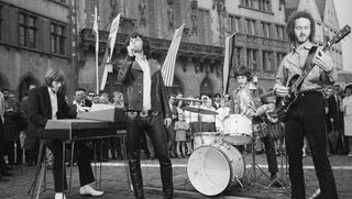 (from left) Ray Manzarek, Jim Morrison, John Densmore, and Robby Krieger perform on the street in Frankfurt, Germany in 1968