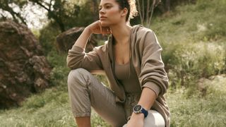 Woman sitting outside wearing Fossil Gen 6 Wellness Edition Smartwatch