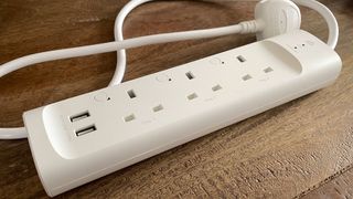 TP-Link Kasa Smart Wi-Fi Powerstrip KP303 on a wooden table