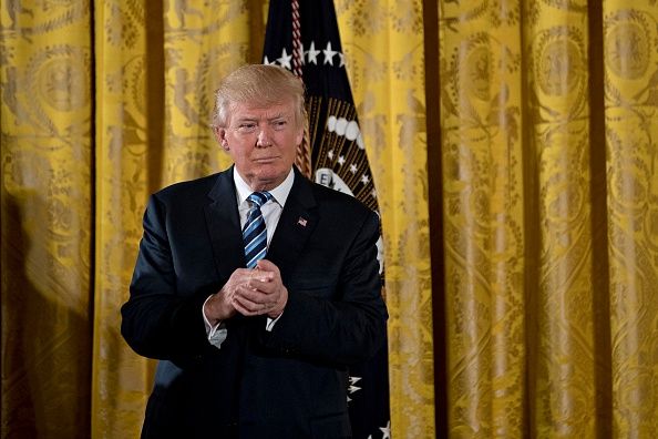 President Donald Trump listens during a swearing in ceremony of senior staff.