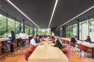 interior of the mutti canteen by carli ratti in parma, the staff canteen and restaurant of the tinned tomato company showing orange floors and glazed facades