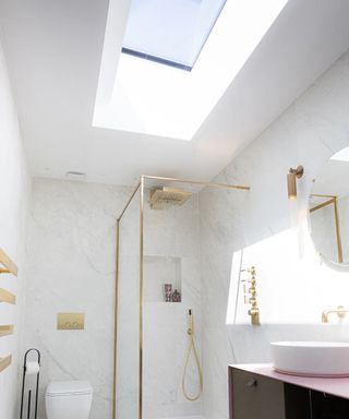 modern white bathroom with large skylight