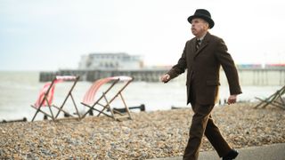 Edward Swan (Timothy Spall) strolls along a beach in Wicked Little Letters