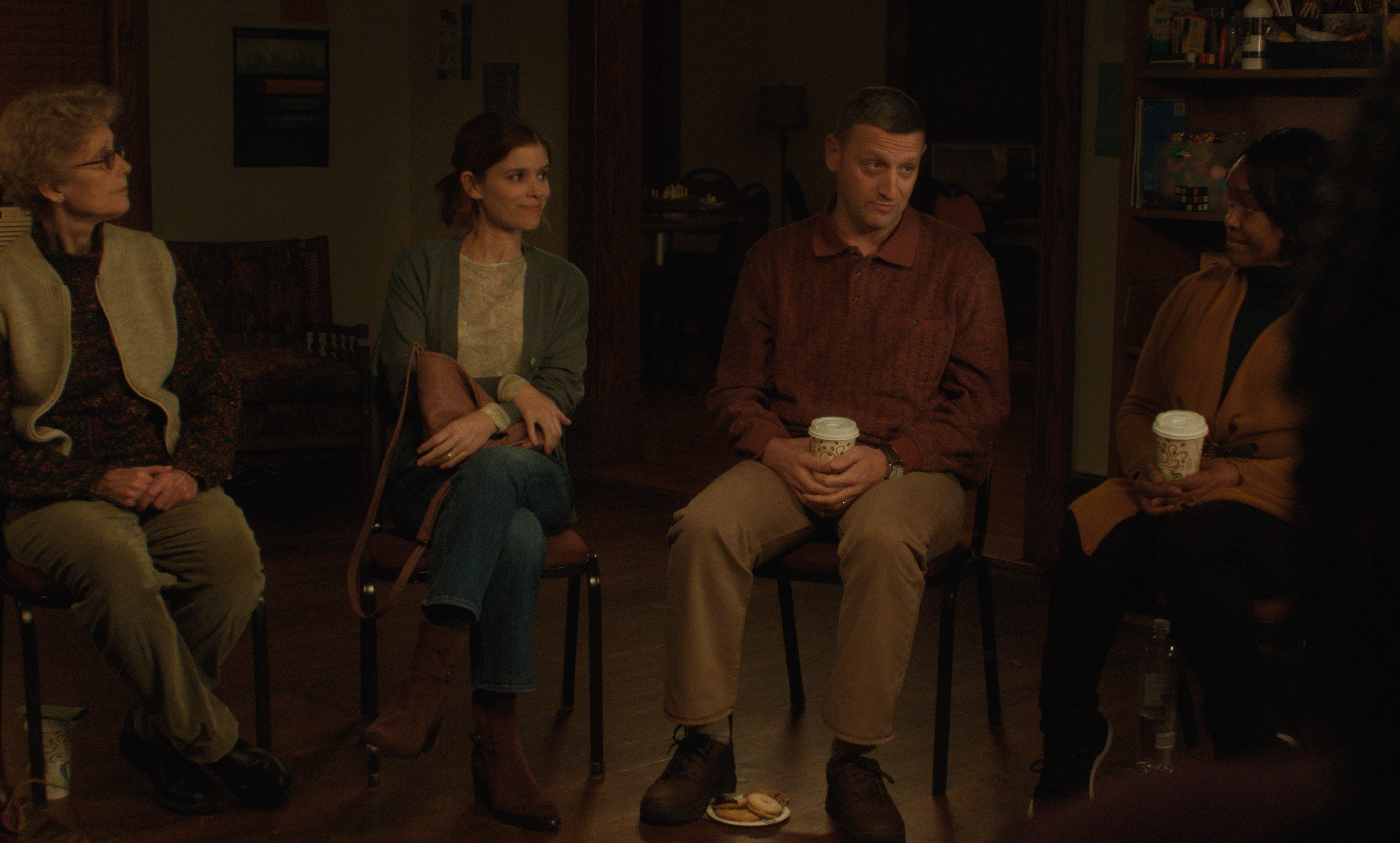 kate mara as tami and tim robinson as craig in a support group in the movie friendship