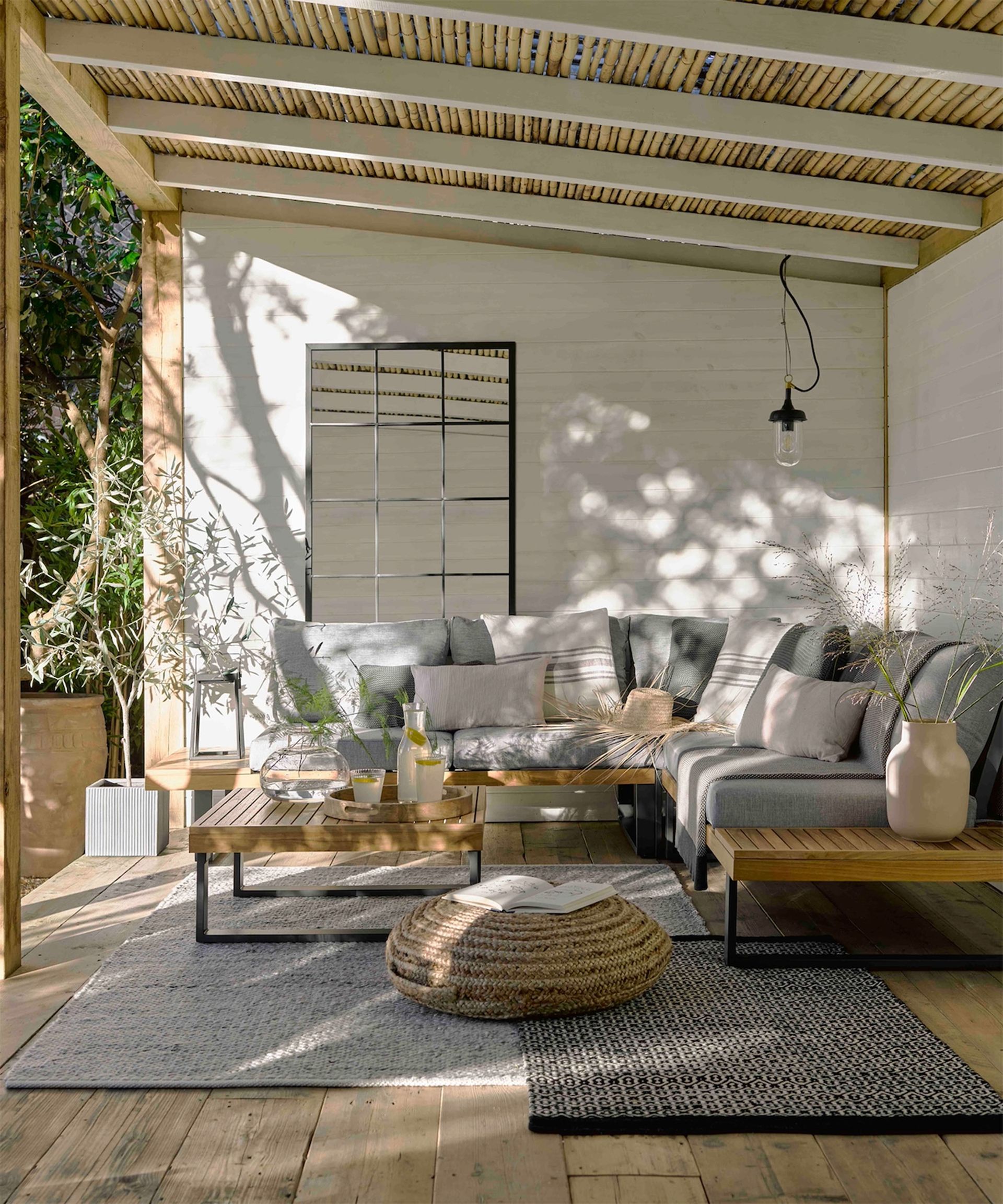 covered wooden deck with furniture and pendant light