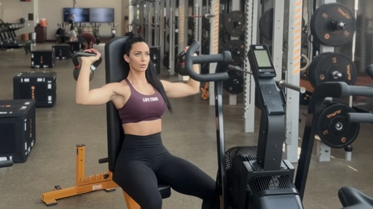Woman exercising with kettlebells in gym