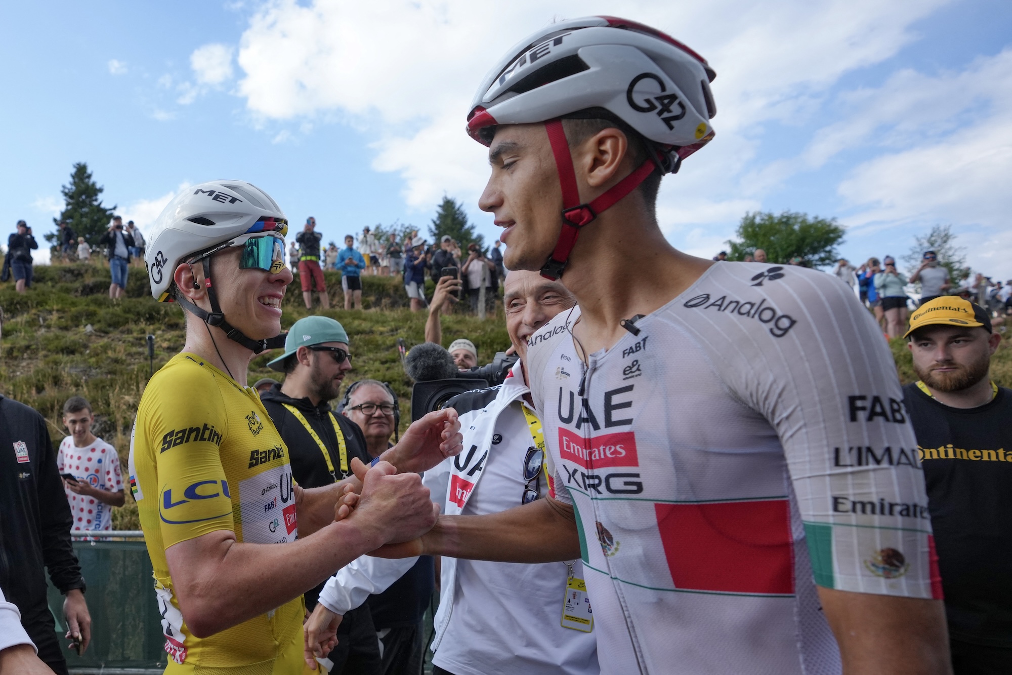 UAE Team Emirates - XRG's Slovenian rider Tadej Pogacar wearing the overall leader's yellow jersey celebrates with UAE Team Emirates - XRG's Mexican rider Isaac Del Toro (R) after winning the 14th stage of the 113th edition of the Tour de France cycling race, 155 km between Mulhouse and Le Markstein in the Vosges mountains, on July 18, 2026. (Photo by Thibault Camus / POOL / AFP)