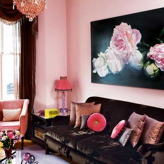 sofa area with brown sofa and pink wall