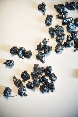 shiny black meteorite stones on table