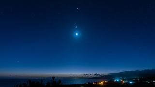 The moon, Venus and Jupiter in the night sky, seen from Iriomote Island, Japan