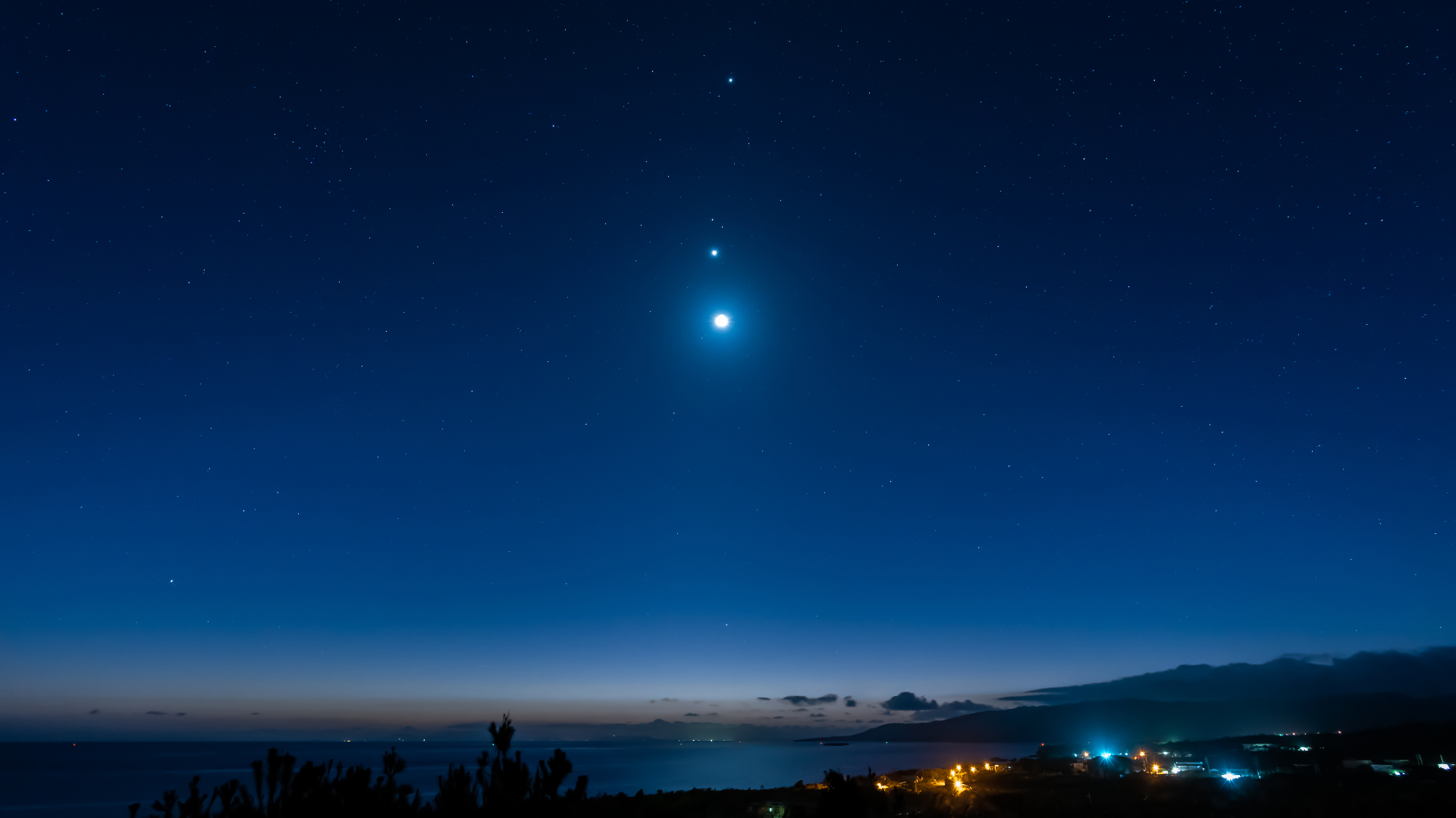 The moon, Venus and Jupiter in the night sky, seen from Iriomote Island, Japan