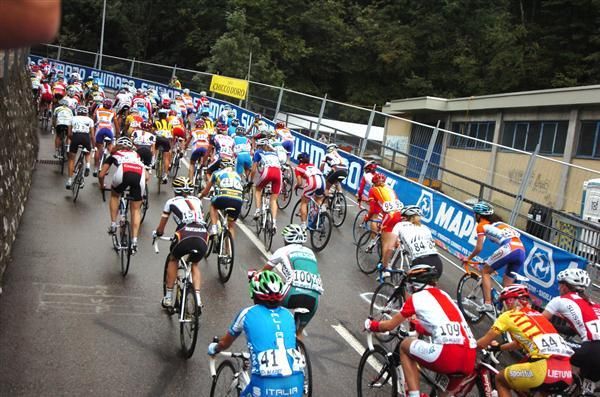 The peloton started on slick roads after rain.