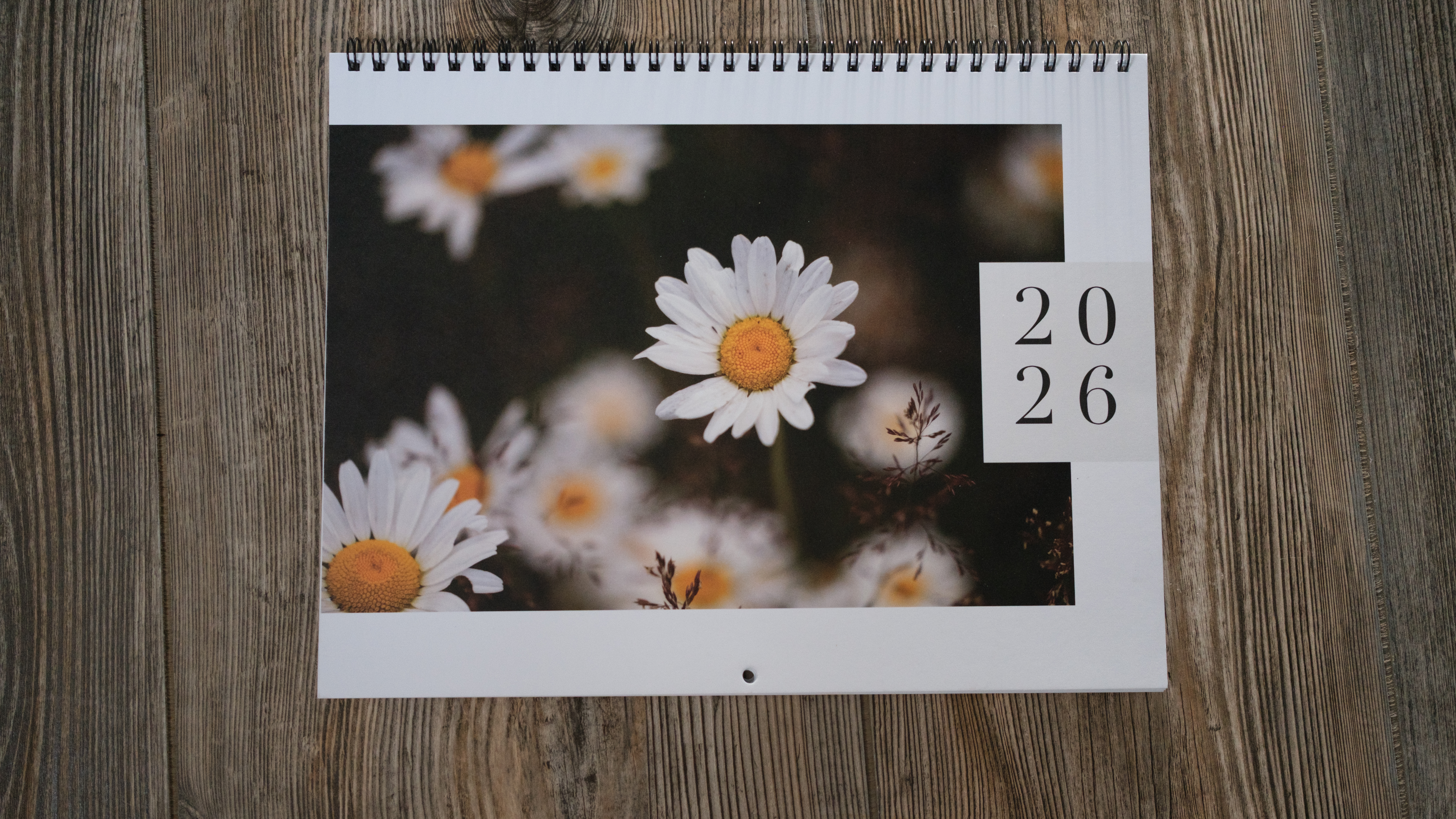 A photo calendar from Mixbook on a wood background