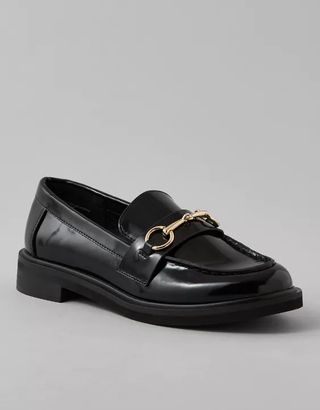 Black loafers with gold hardware