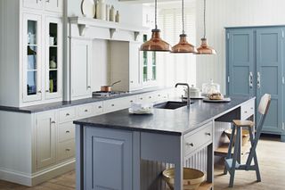 Artisan kitchen with blue island and copper pendant lights