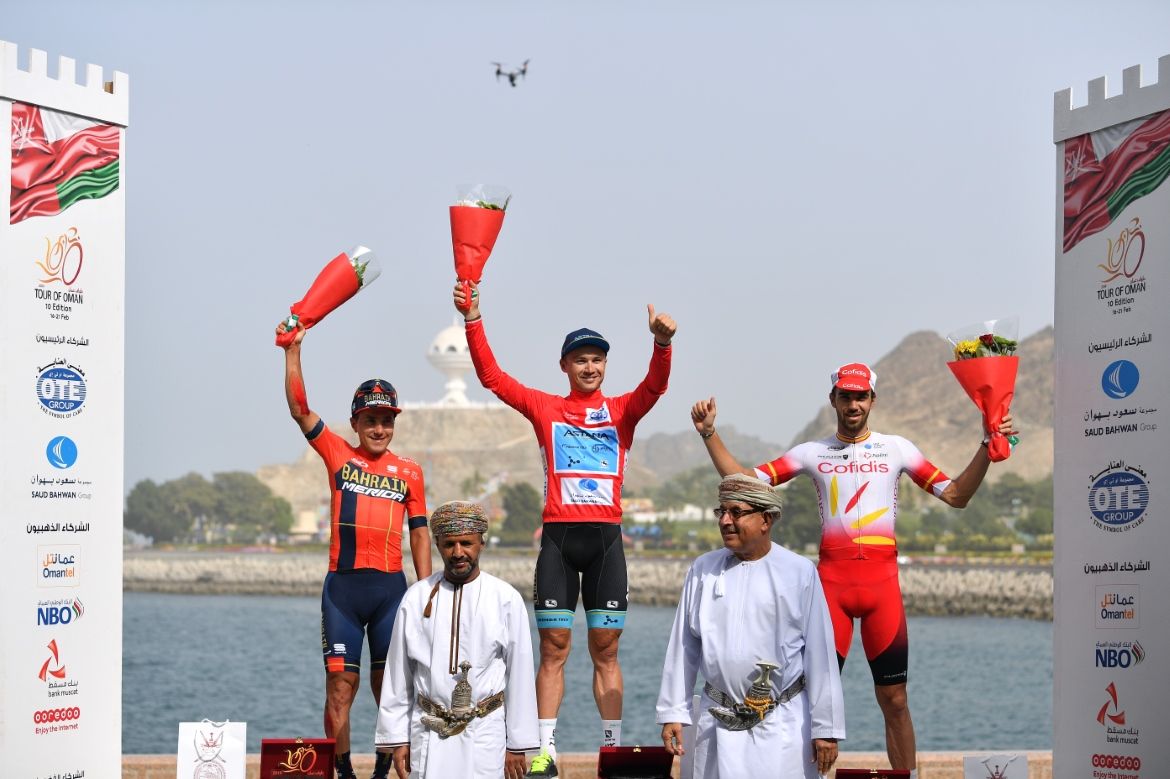Alexey Lutsenko (Astana) waves from the top step of the Tour of Oman podium
