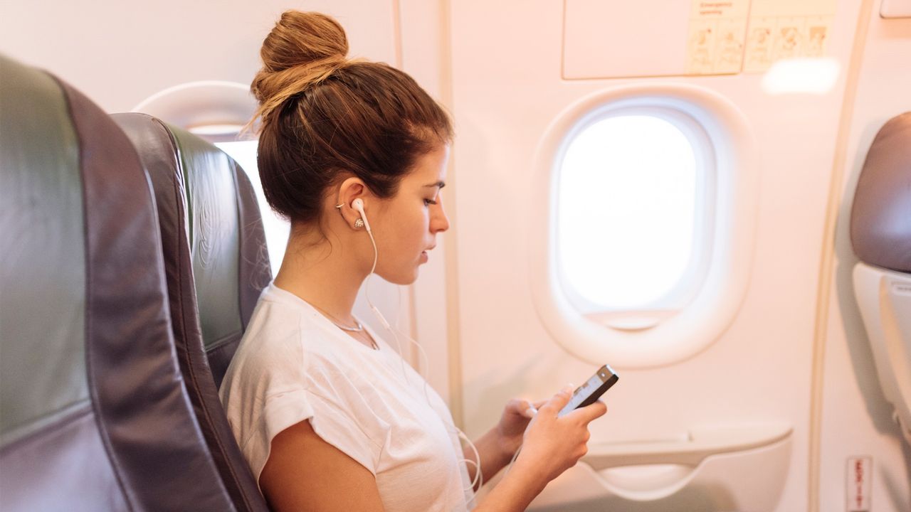 Woman on her phone on a plane