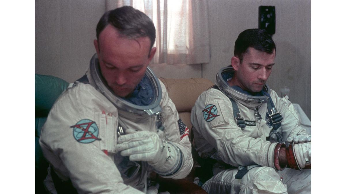 Astronauts Michael Collins (left) and John W. Young (right) suit up during the countdown for NASA's Gemini 10 spaceflight.