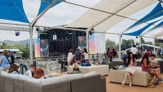 Stage equipment, Shade, Stage, Music venue, Couch, Tent, studio couch, Canopy, Coffee table, Outdoor furniture,