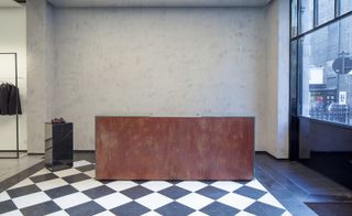 The slick, largely black and white interior works upwards from the store’s original chequerboard tiles