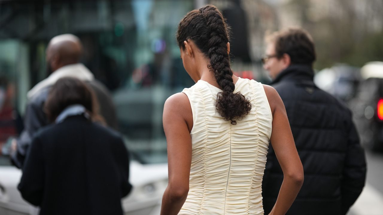 A woman with a curly braided hairstyle.