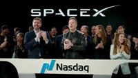 Elon Musk claps after SpaceX begins trading on the Nasdaq