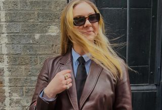 Copelyn Bengel wearing a Quince blue button-down shirt, black tie, and burgundy leather jacket.