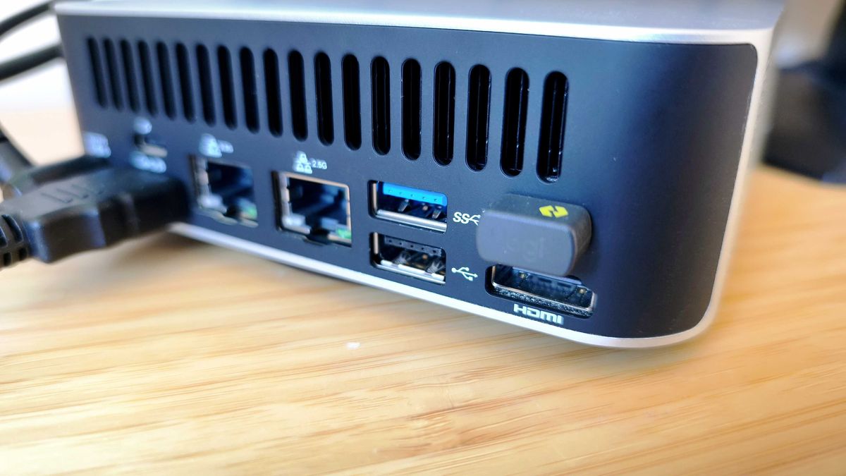 A silver Geekom A9 Max on a wooden desk