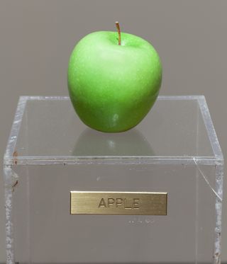 Apple on clear plinth