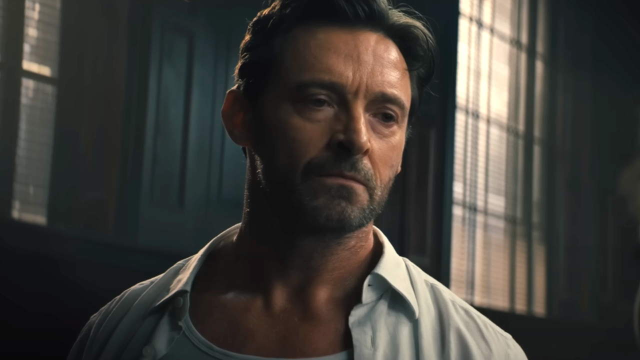 Hugh Jackman looking down with a face of disappointment in Reminiscence.