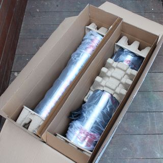 The Swan Column patio heater being unboxed on wooden decking