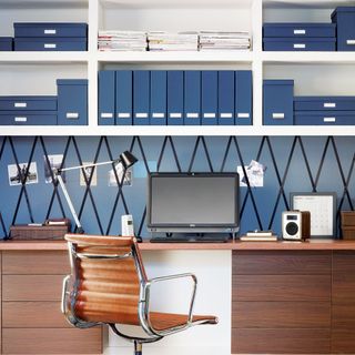 Home office with white open shelving and matching blue box files