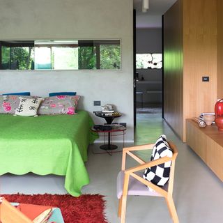 bedroom with green bed and red carpet