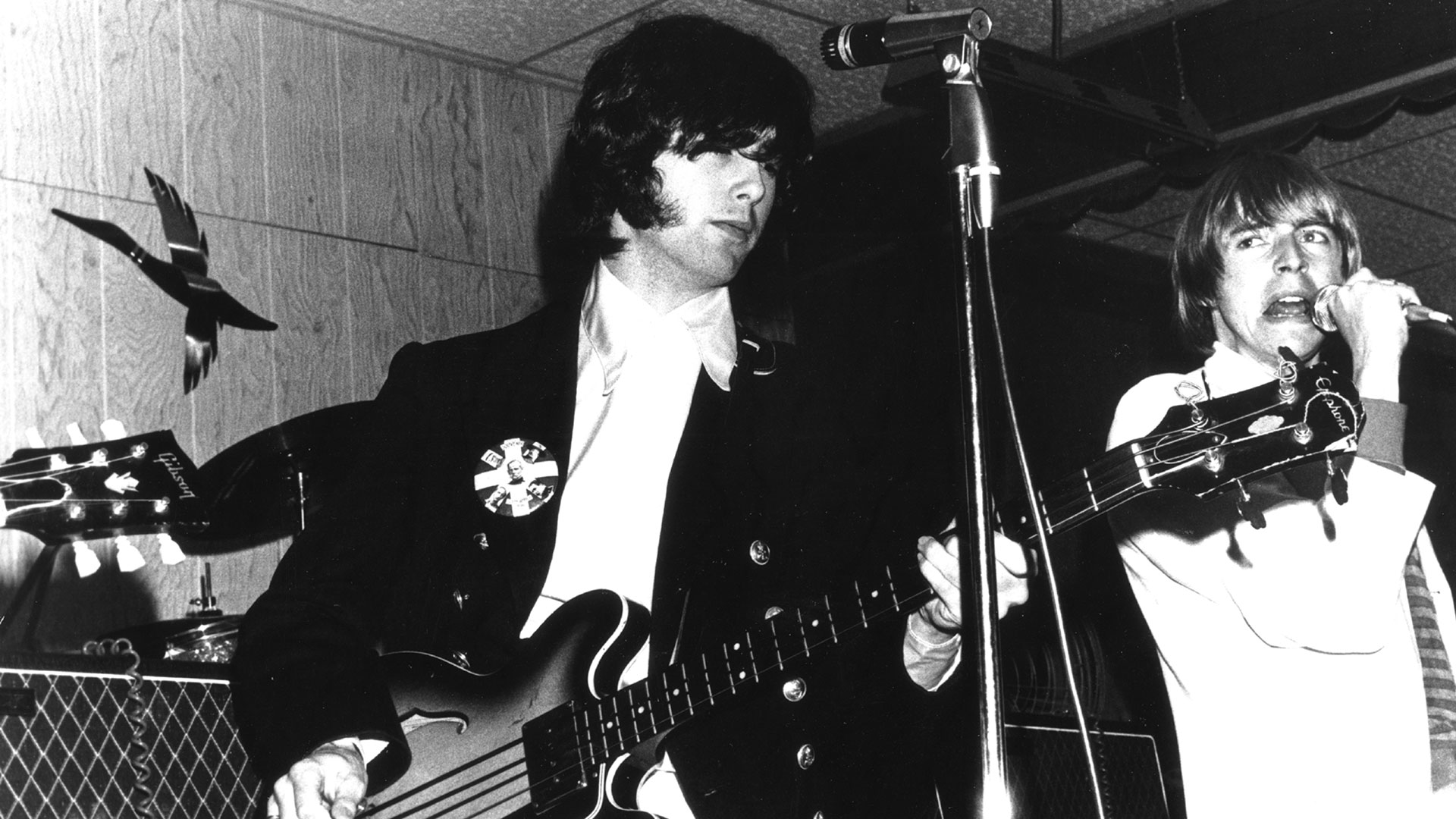 Black and white image of Jimmy Page (left) playing bass onstage with The Yardbirds and (right) singer Keith Relf at Green's Pavilion in Lakeview Park on August 10, 1966 in Manitou Beach, MI