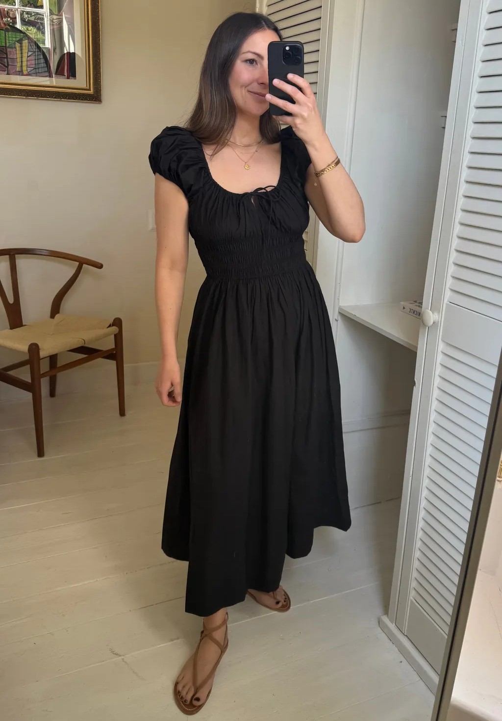 petite fashion editor wears black dress and brown sandals