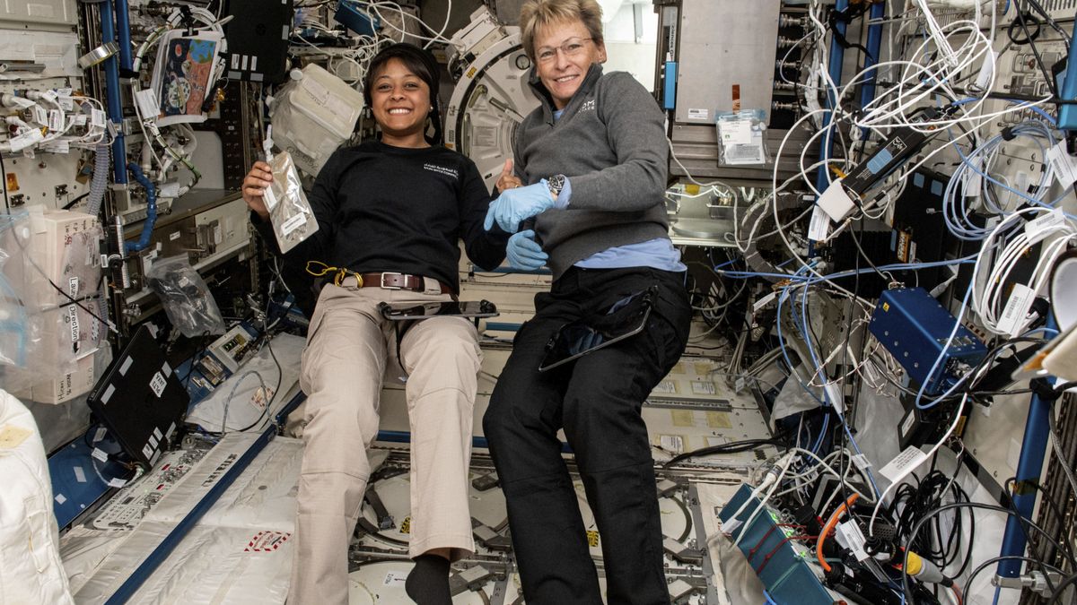 Axiom Space Ax-2 astronauts Rayyanah Barnawi on the left and Ax-2 commander Peggy Whitson smile for a photo surrounded by science gear on International Space Station.