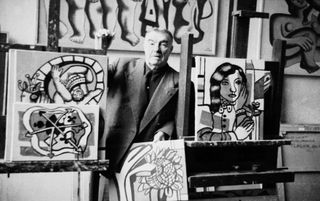 Fernand Léger posing with his paintings