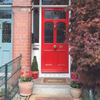 Red front door on a terraced house.