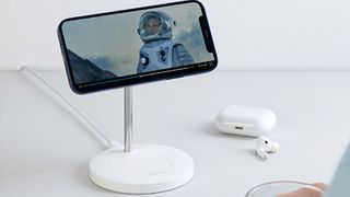 iPhone charging with Anker Wireless Charging Stand, PowerWave 2-in-1 Magnetic Stand Lite with AirPods nearby.